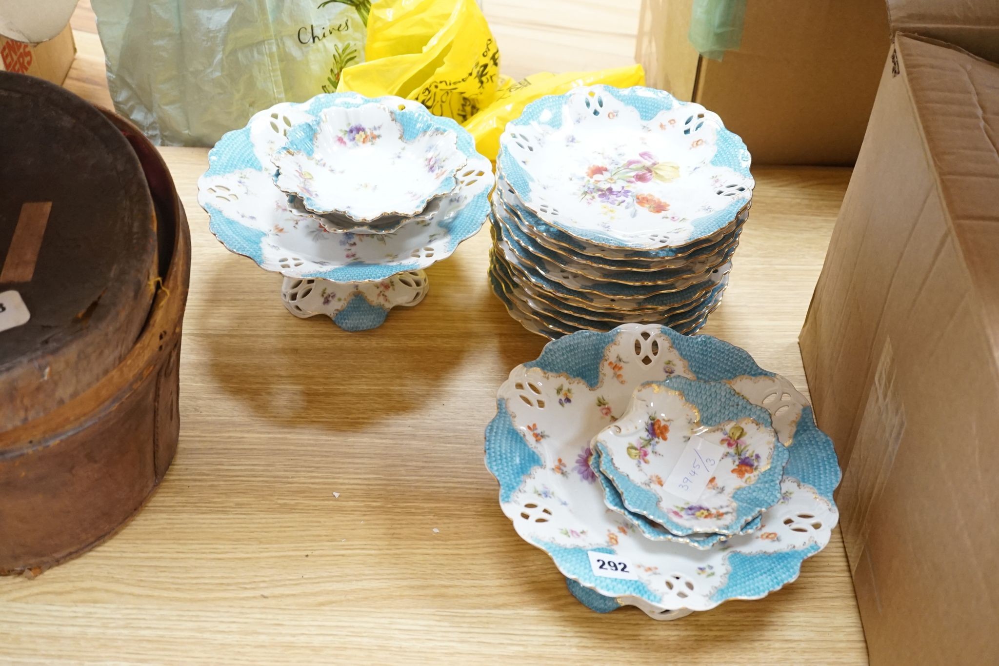 A floral and gilt dessert set, comprising of: 3 comports, 10 plates and 6 assorted dishes.